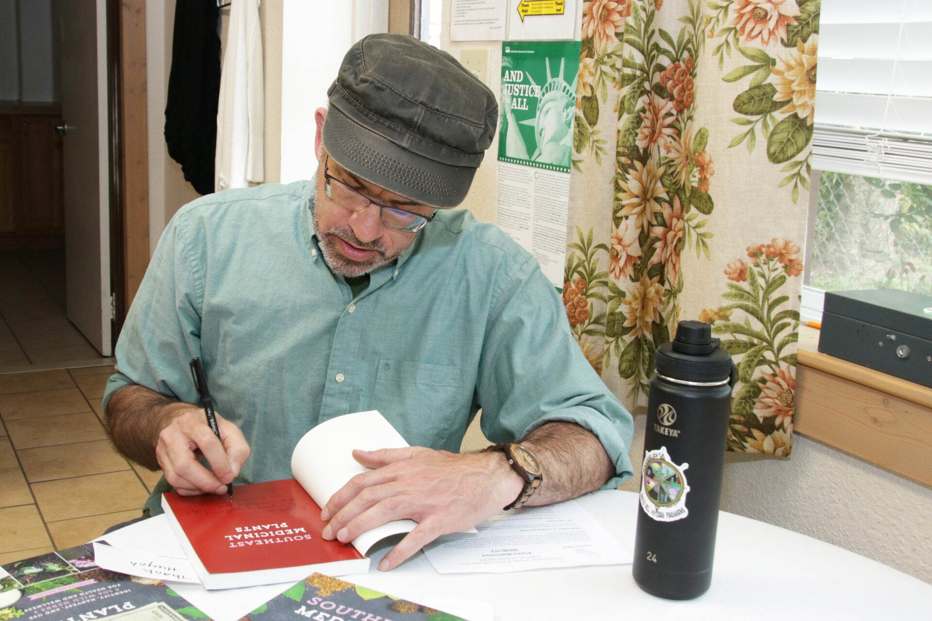 Author CoreyPine Shane autographs his book