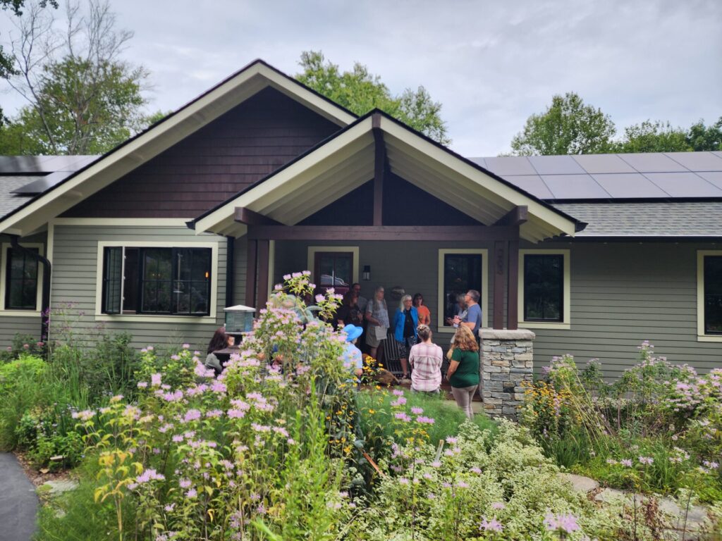 Group listening to presentation in front of home