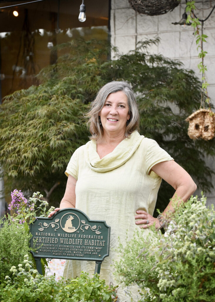 Robin Davis, owner of Maxie B's and creator of certified wildlife habitat in front of the store (photo by Heather Pinho)
