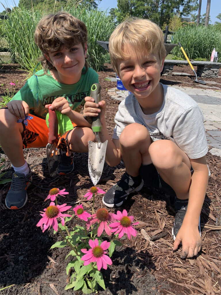 Kids digging in a flower garden